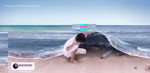 Picture of child lifting the edge of the ocean to reveal plastic bottles 